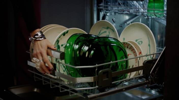 A basket full of plates to wash