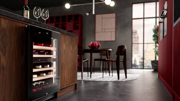 Kitchen view with Wine cellar attached to kitchen table having wine glasses on the table